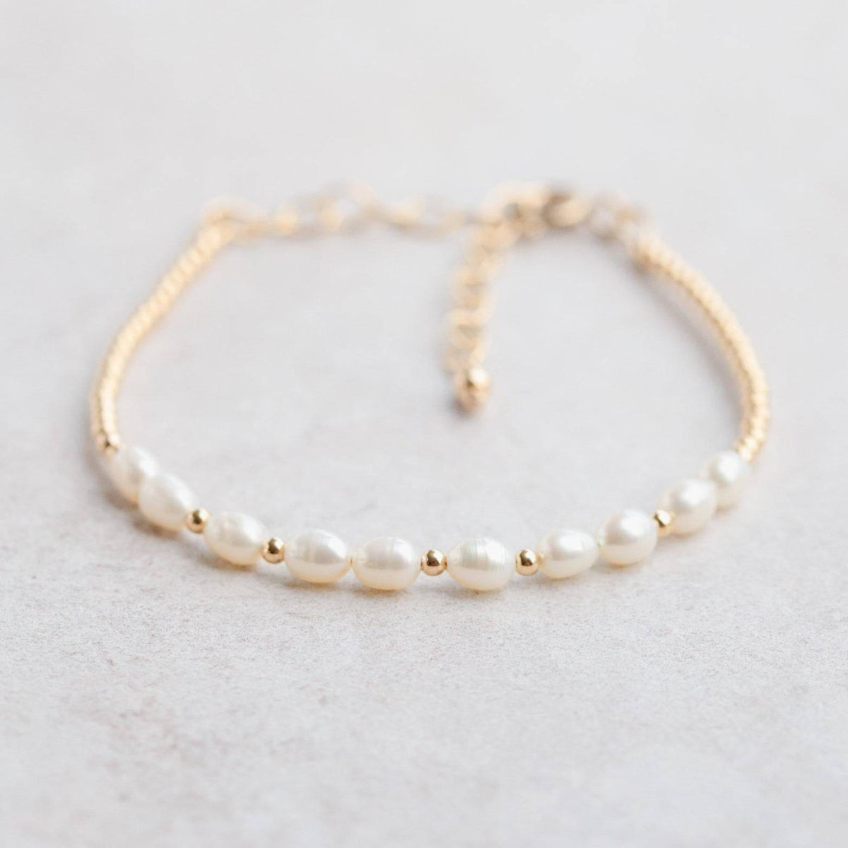 Freshwater pearl from Earthly Abundance Jewelry displayed in a jewelry setting, showcasing its smooth, lustrous surface and elegant shape.
