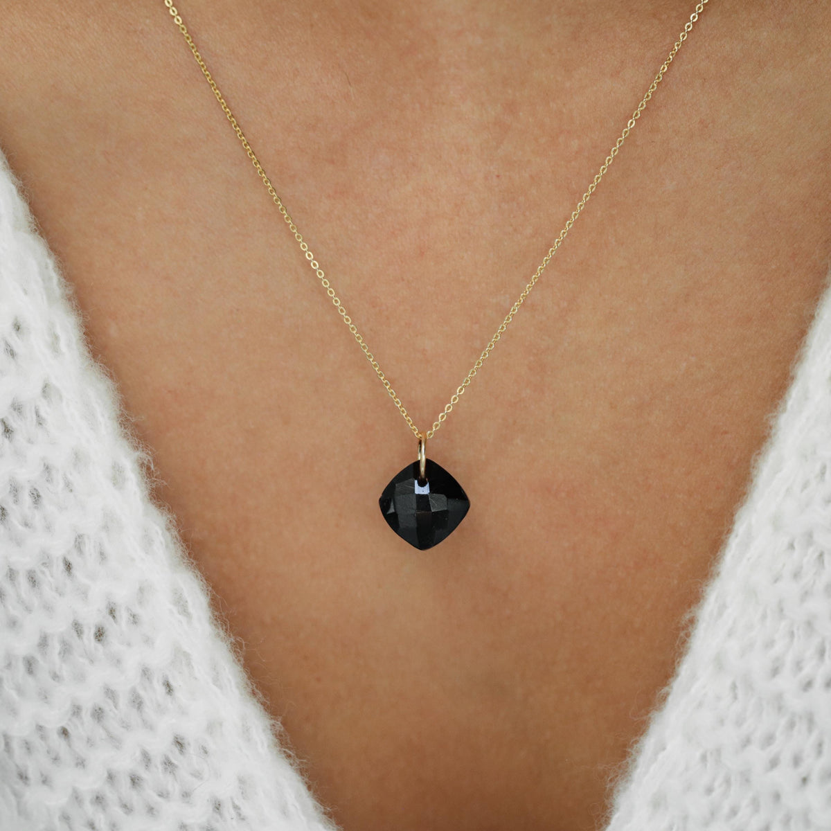 Black Tourmaline faceted pendant from Earthly Abundance featuring a polished, faceted black gemstone necklace pendant.