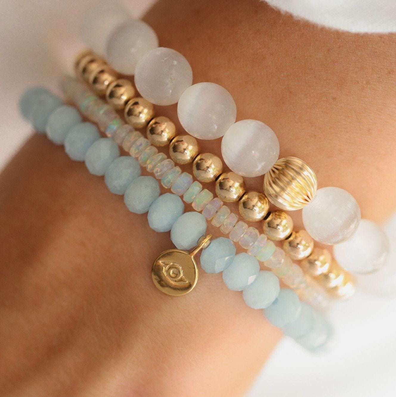 Aquamarine evil eye bracelet by Earthly Abundance Jewelry featuring blue gemstone beads and protective evil eye charm.