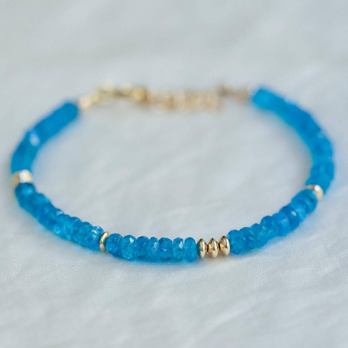 Zambia Apatite bracelet from Earthly Abundance Jewelry featuring polished blue-green apatite stones on a stretch cord.