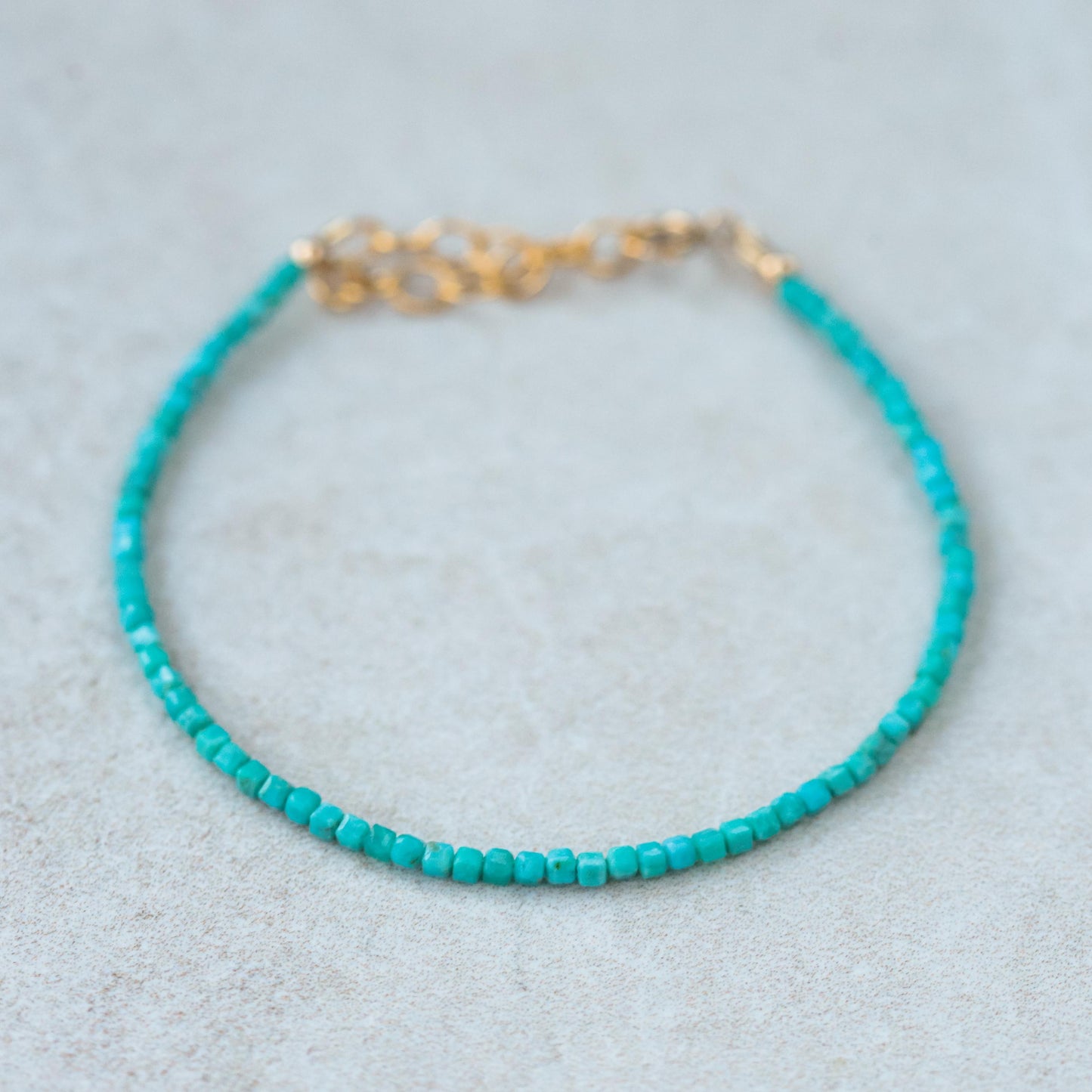 Earthly Abundance Cube-Cut gemstone bracelet in 14K gold with geometric design, showcased on a neutral background.
