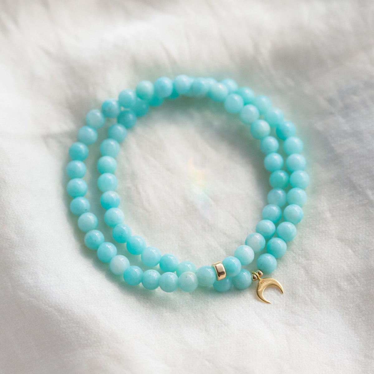 Peruvian Amazonite bracelet with 5mm beads from Earthly Abundance, showcasing smooth, polished turquoise-colored stones on a white background.