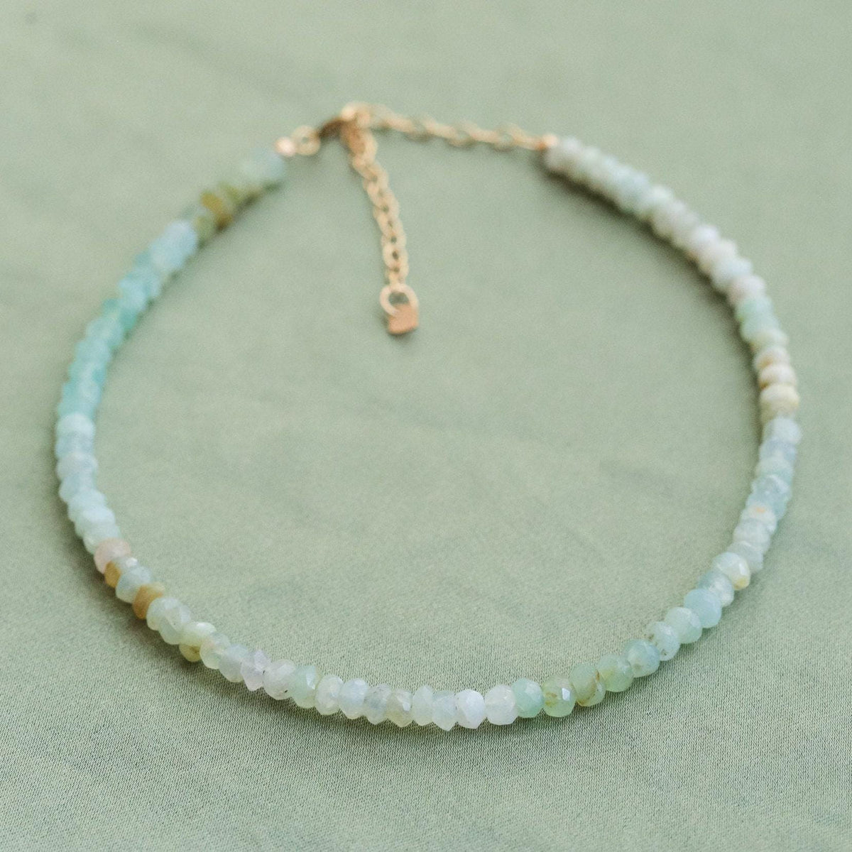 Peruvian opal anklet with beads and silver accents, handcrafted jewelry from Earthly Abundance showing a close-up of the design.