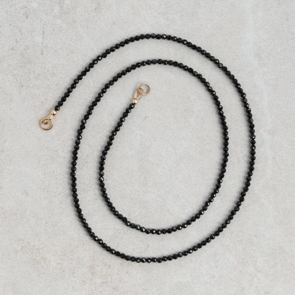 Lore Black Tourmaline necklace with 14K gold chain, featuring a polished black tourmaline pendant, from Earthly Abundance.