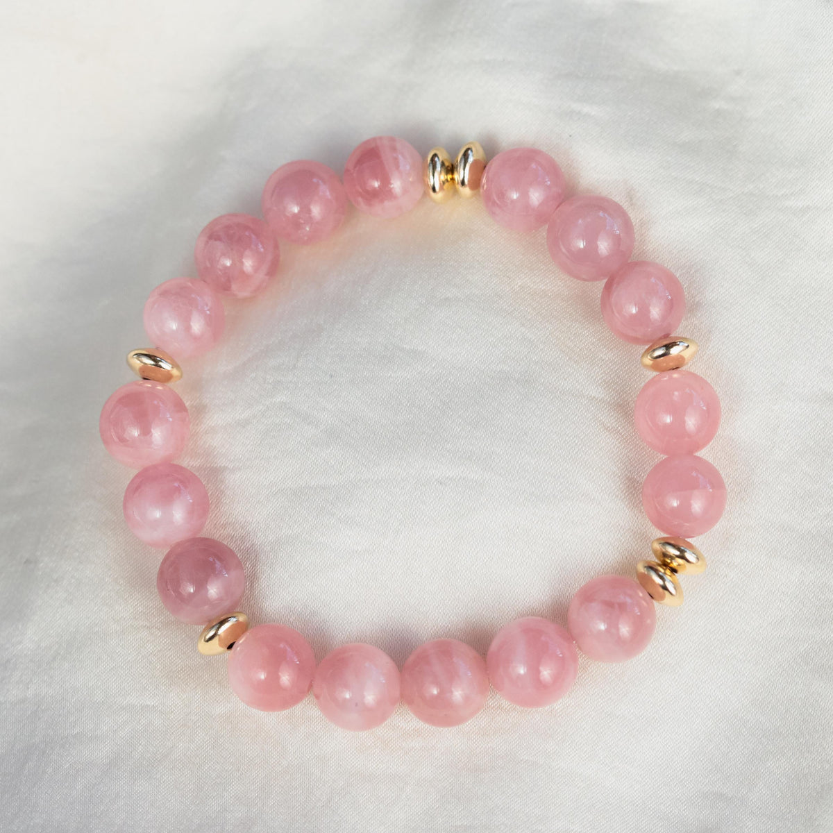 10mm Madagascar Rose Quartz bracelet by Earthly Abundance featuring pink gemstone beads on an elastic stretch band.