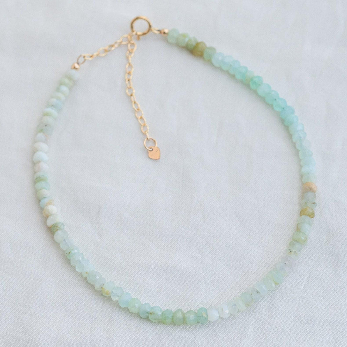 Earthly Abundance Laguna Peruvian Opal anklet featuring colorful oval gemstones on a delicate silver chain.