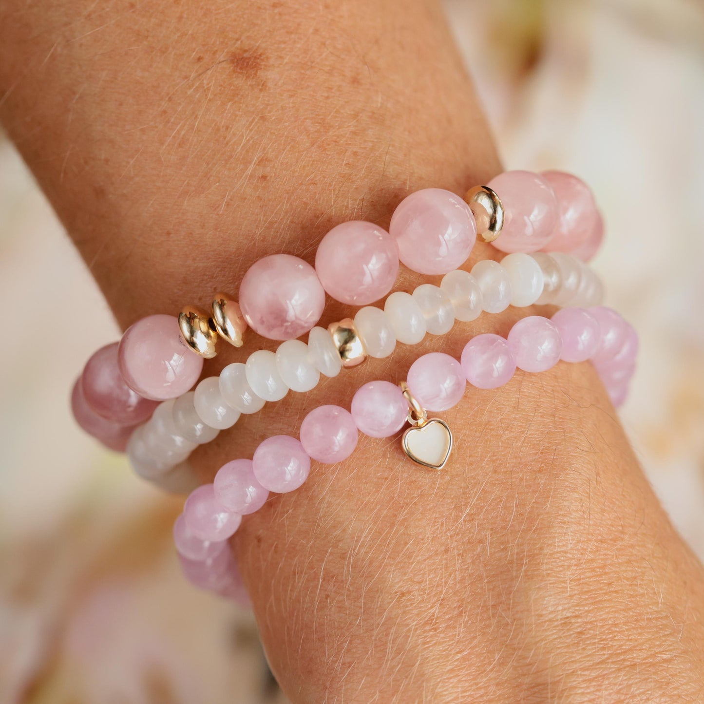 Madagascar Rose Quartz bracelet with 10mm beads from Earthly Abundance, showcasing pink, polished gemstone beads on a stretch cord.
