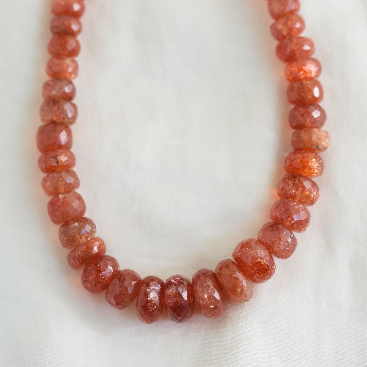 14K Sunstone necklace featuring a vibrant, polished sunstone pendant on a delicate chain, crafted by Earthly Abundance.