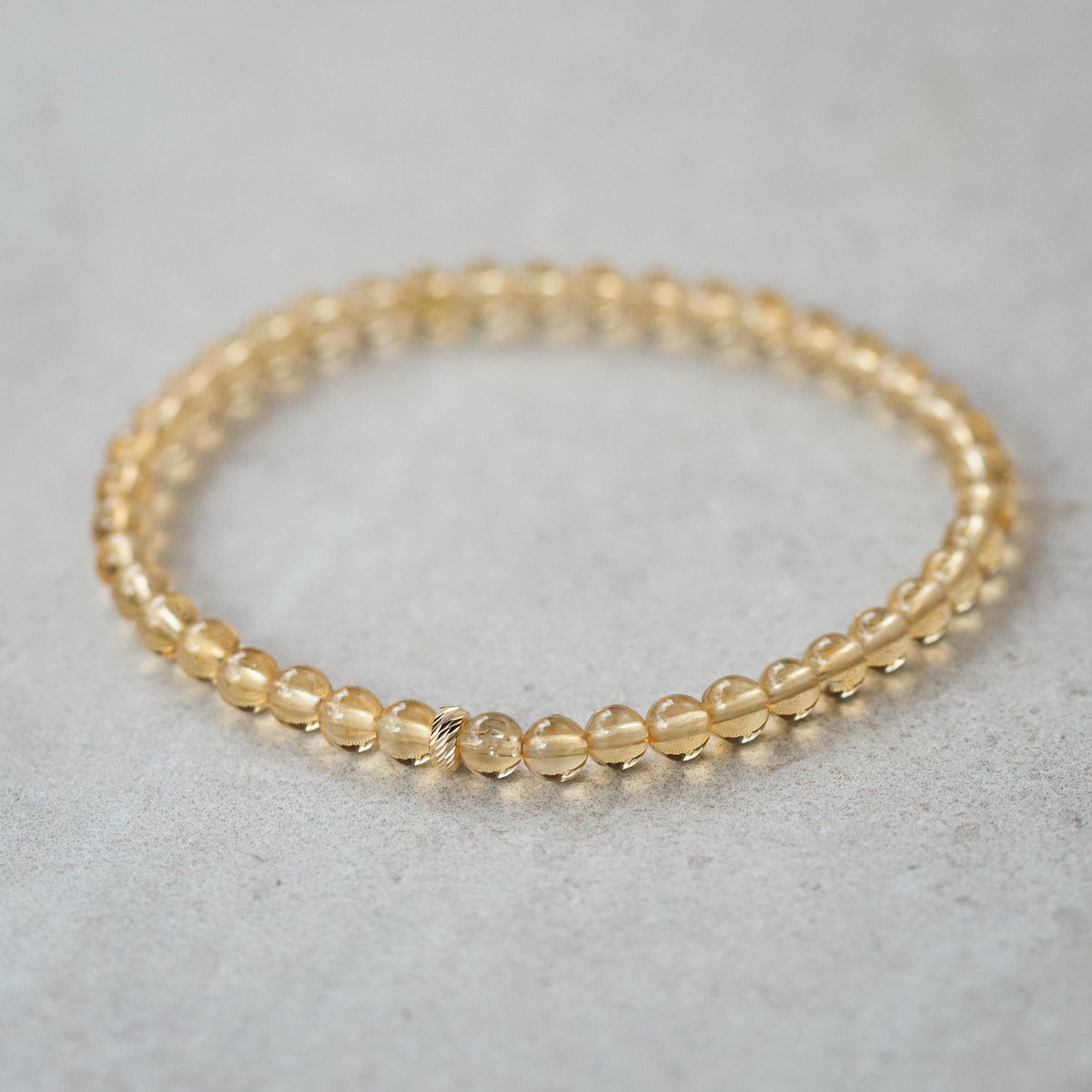 Earthly Abundance Solar Citrine bracelet with 14K gold accents, featuring polished, faceted citrine gemstones on a delicate chain.