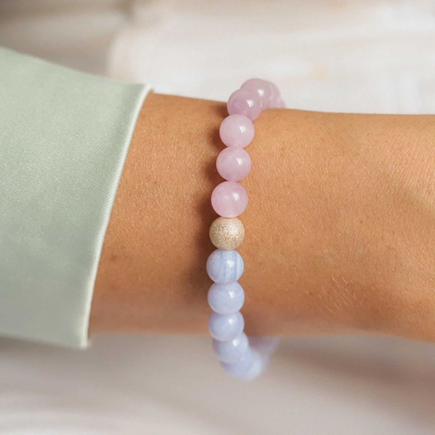 Blue Lace Agate and Kunzite gemstones from Earthly Abundance, showcasing their vibrant colors and intricate natural patterns.