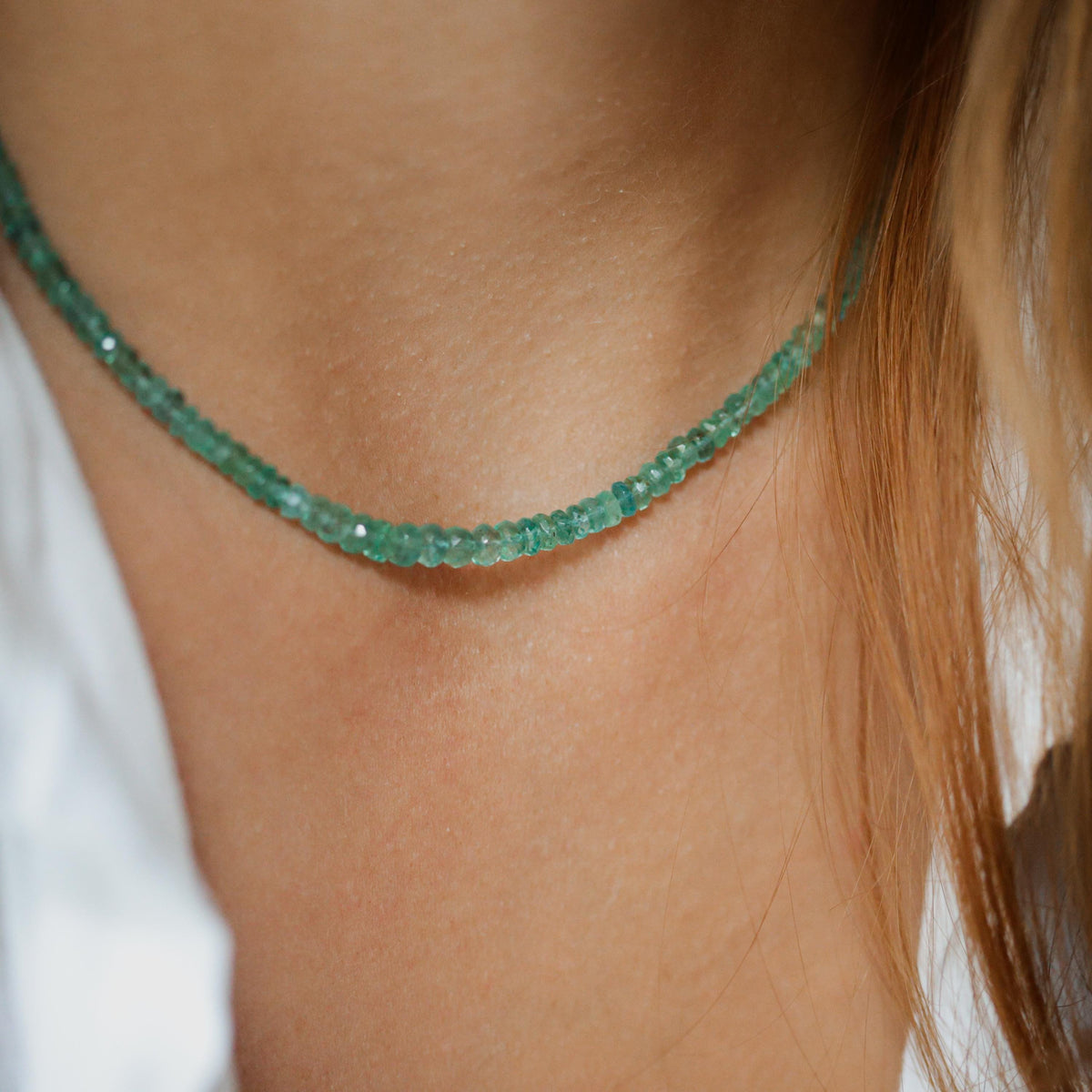 Zambian emerald necklace with 14K gold setting featuring a vibrant green emerald gemstone on a delicate chain.