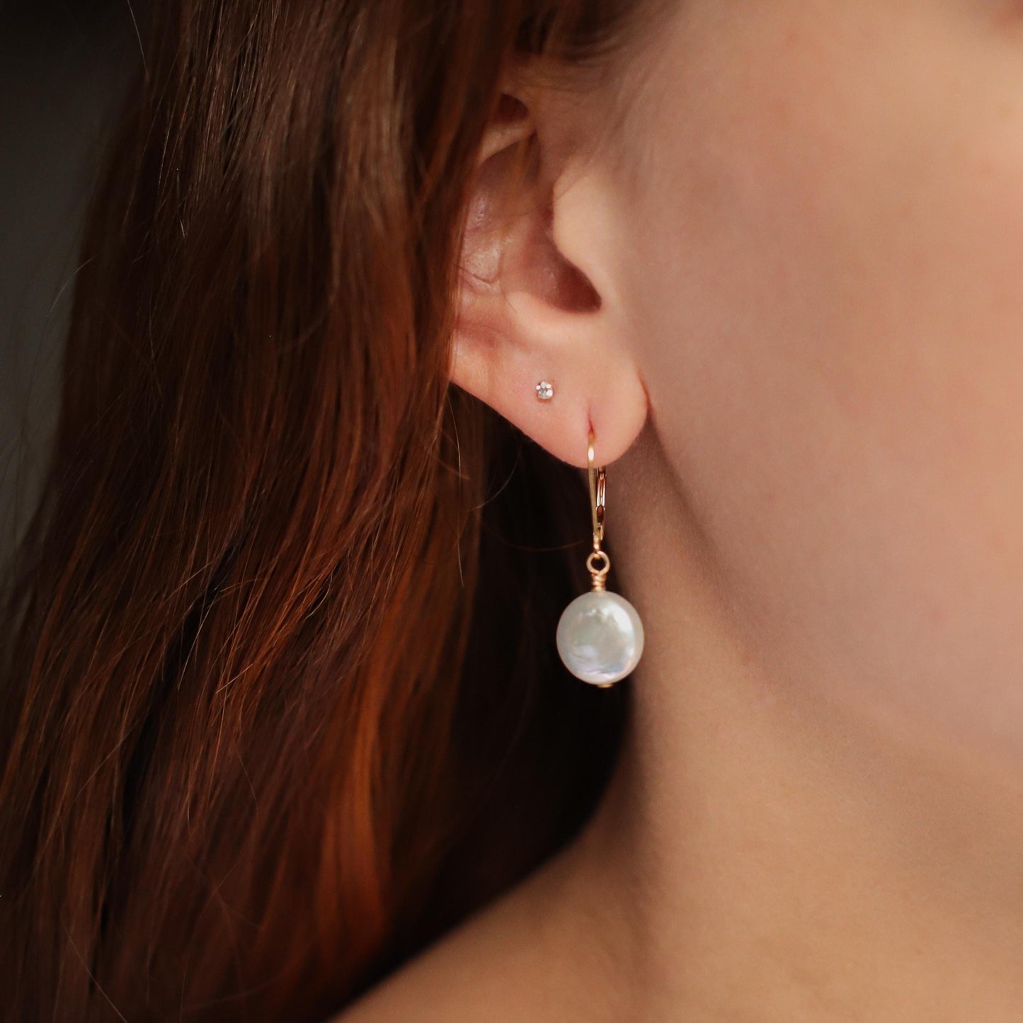 Pair of freshwater disc pearl earrings in 14K gold with smooth, round pearls, showcasing elegant jewelry design.