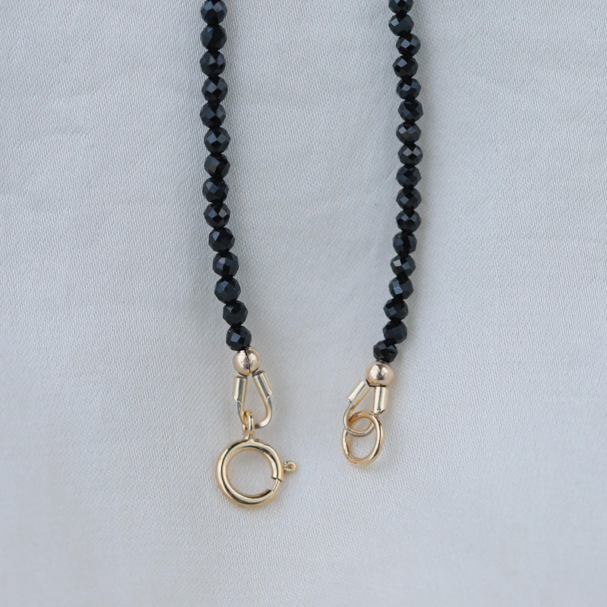 Black spinel necklace from Earthly Abundance Jewelry featuring a sleek, elegant black gemstone pendant on a delicate chain.