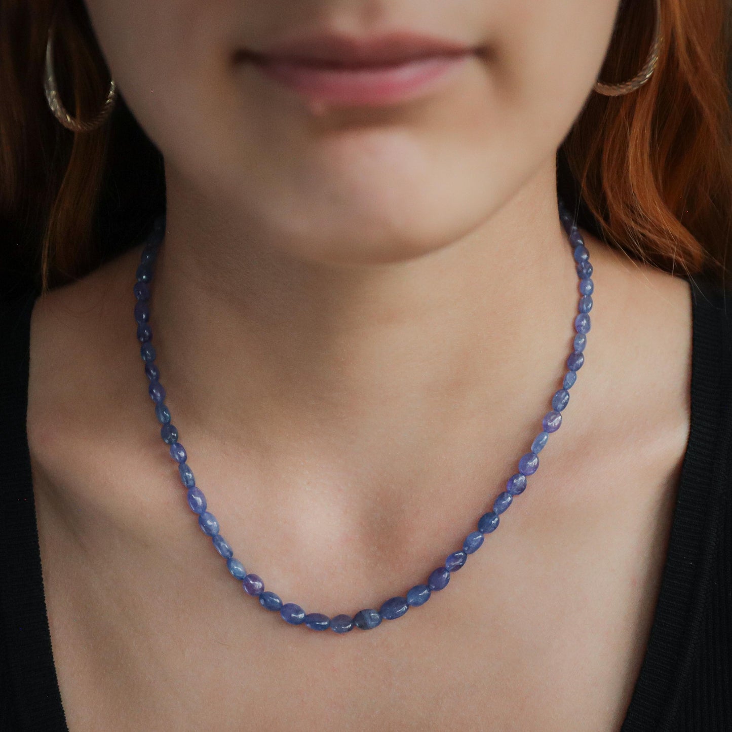 Oval Tanzanite necklace in 14K gold from Earthly Abundance, featuring a vibrant blue-purple gemstone on a delicate chain.
