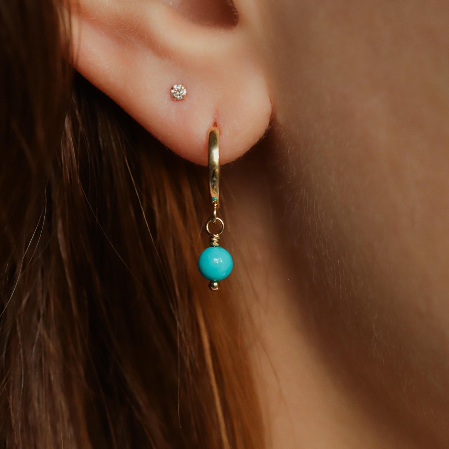 Sleeping Beauty turquoise hoop earrings in 14K gold by Earthly Abundance, featuring vibrant blue turquoise stones and gold hoops.