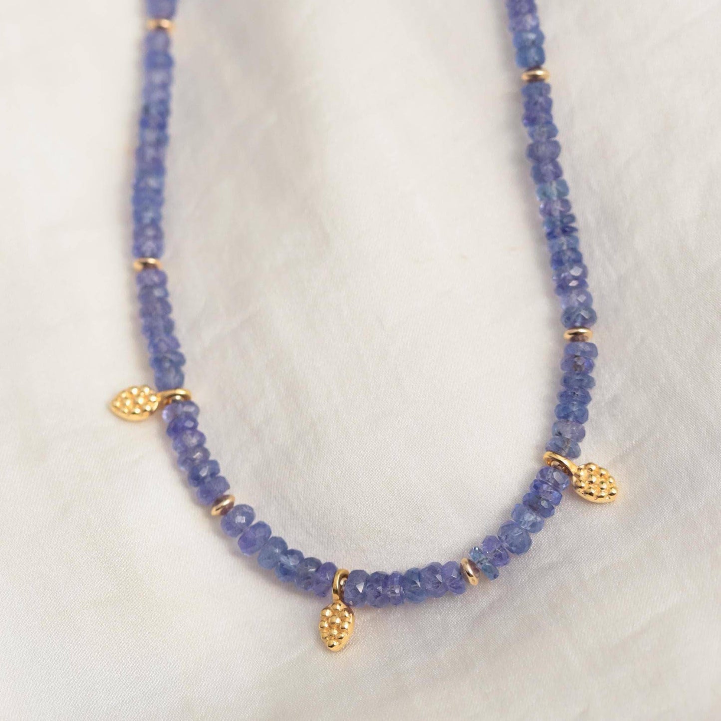 Elegant Tanzanite necklace by Earthly Abundance featuring a stunning violet-blue gemstone on a delicate silver chain.