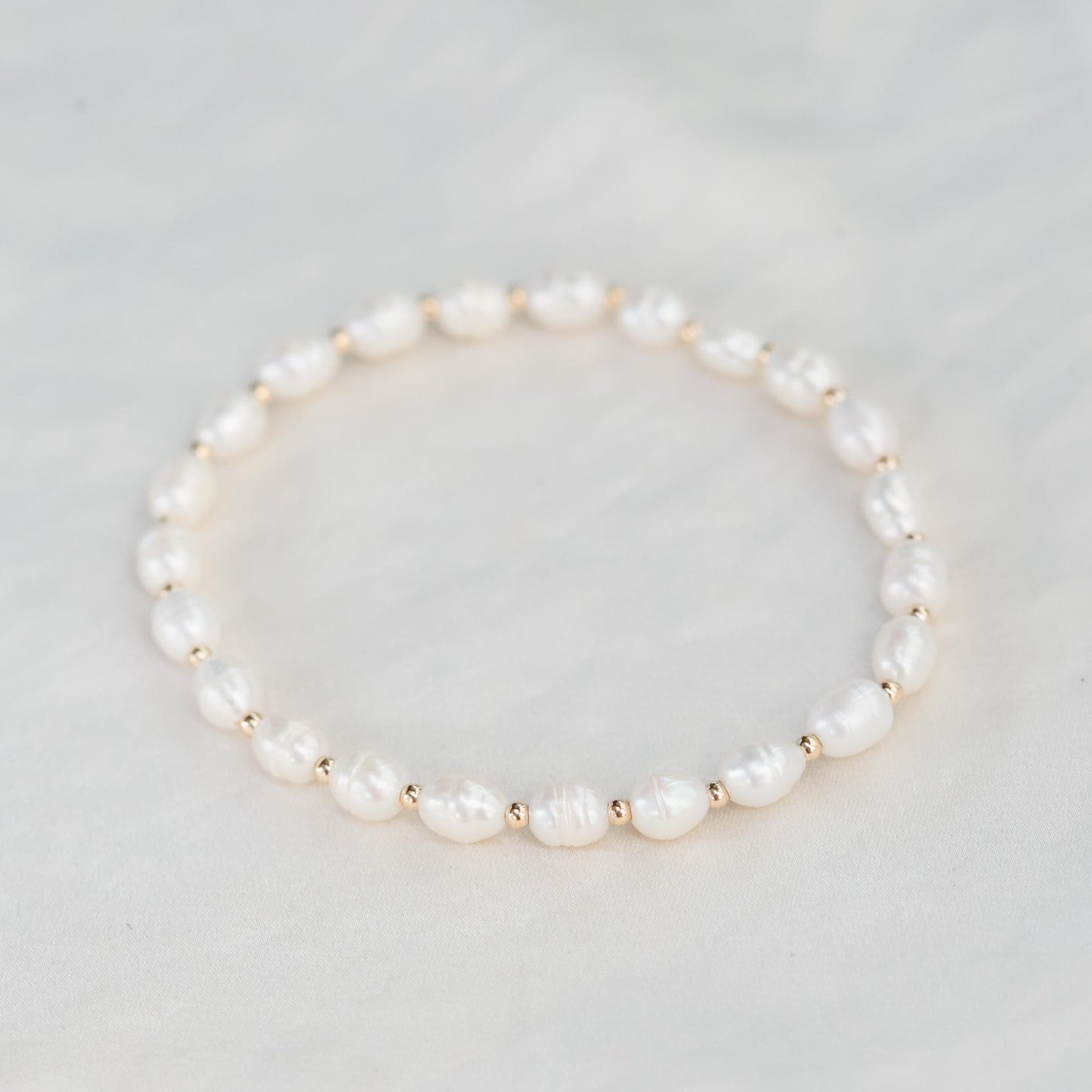 Soft Radiance Pearl bracelet in 14K gold from Earthly Abundance, featuring smooth pearls and elegant gold clasp.
