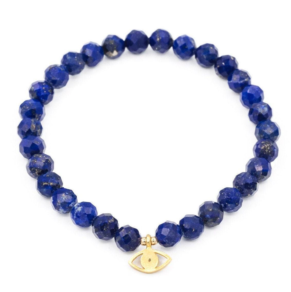 Faceted lapis lazuli bracelet with deep blue stones and gold-tone accents, handcrafted by Earthly Abundance Jewelry