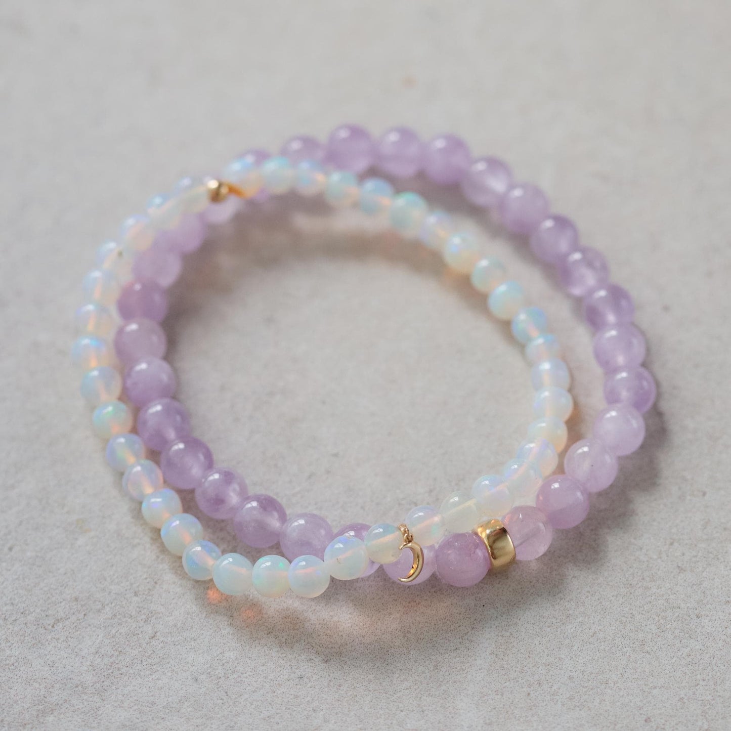 Ethiopian Opal Moon Bracelet with 14K gold setting from Earthly Abundance, featuring moon-shaped opal charms and delicate chain.