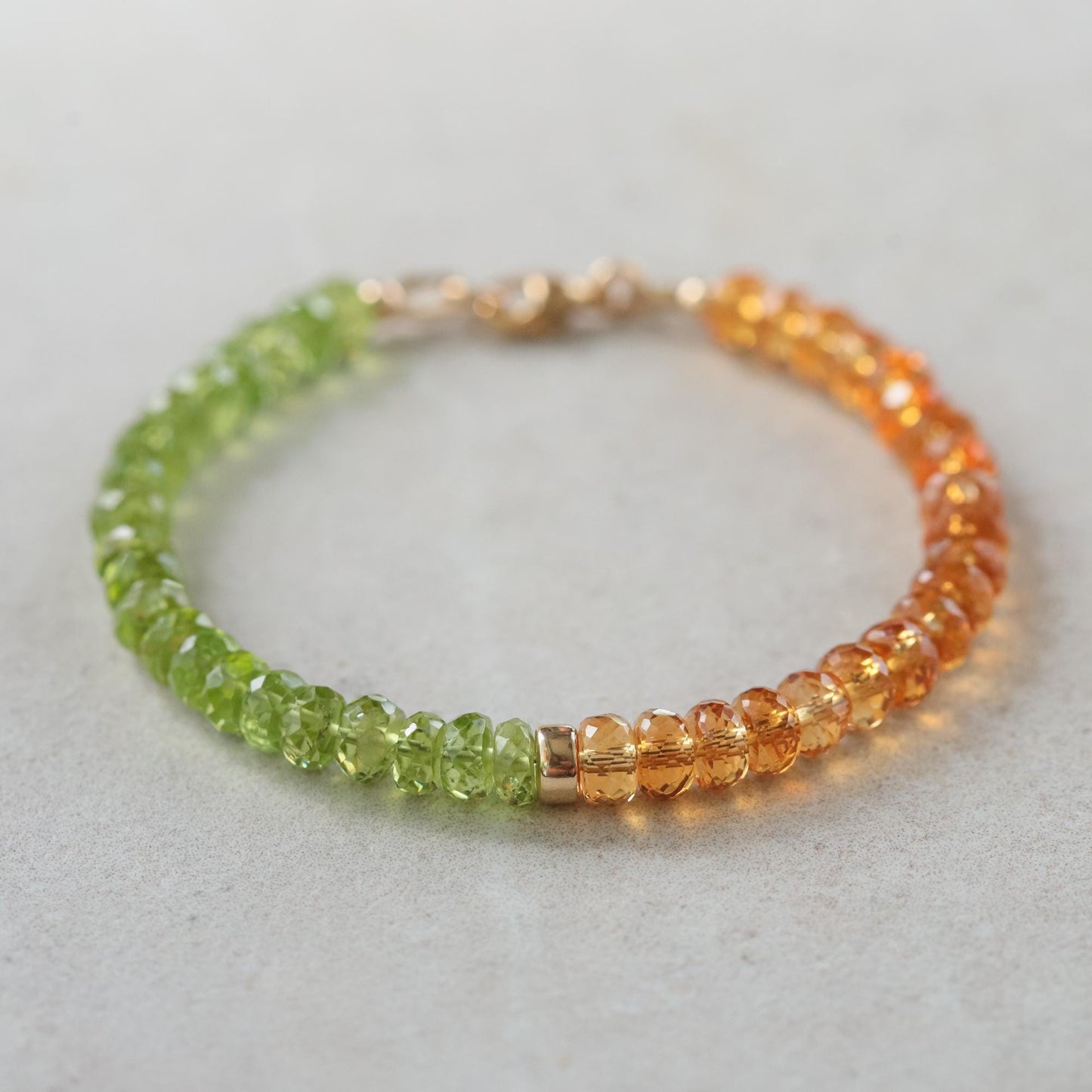 Peridot and citrine bracelet with gold accents from Earthly Abundance, featuring vibrant green and yellow gemstones.