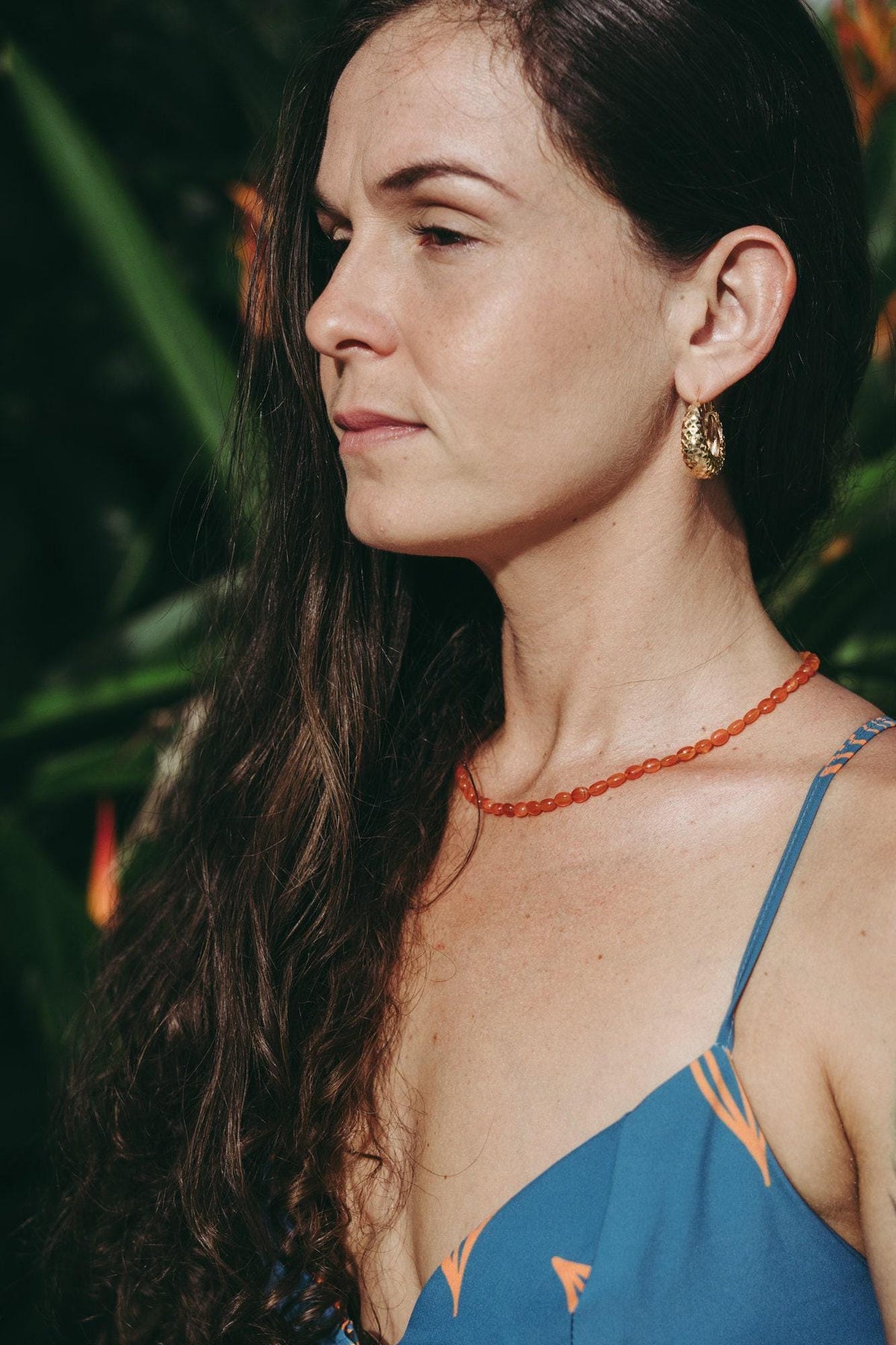 Earthly Abundance Jewelry Carnelian beaded oval necklace featuring vibrant orange-red oval beads on a delicate string.