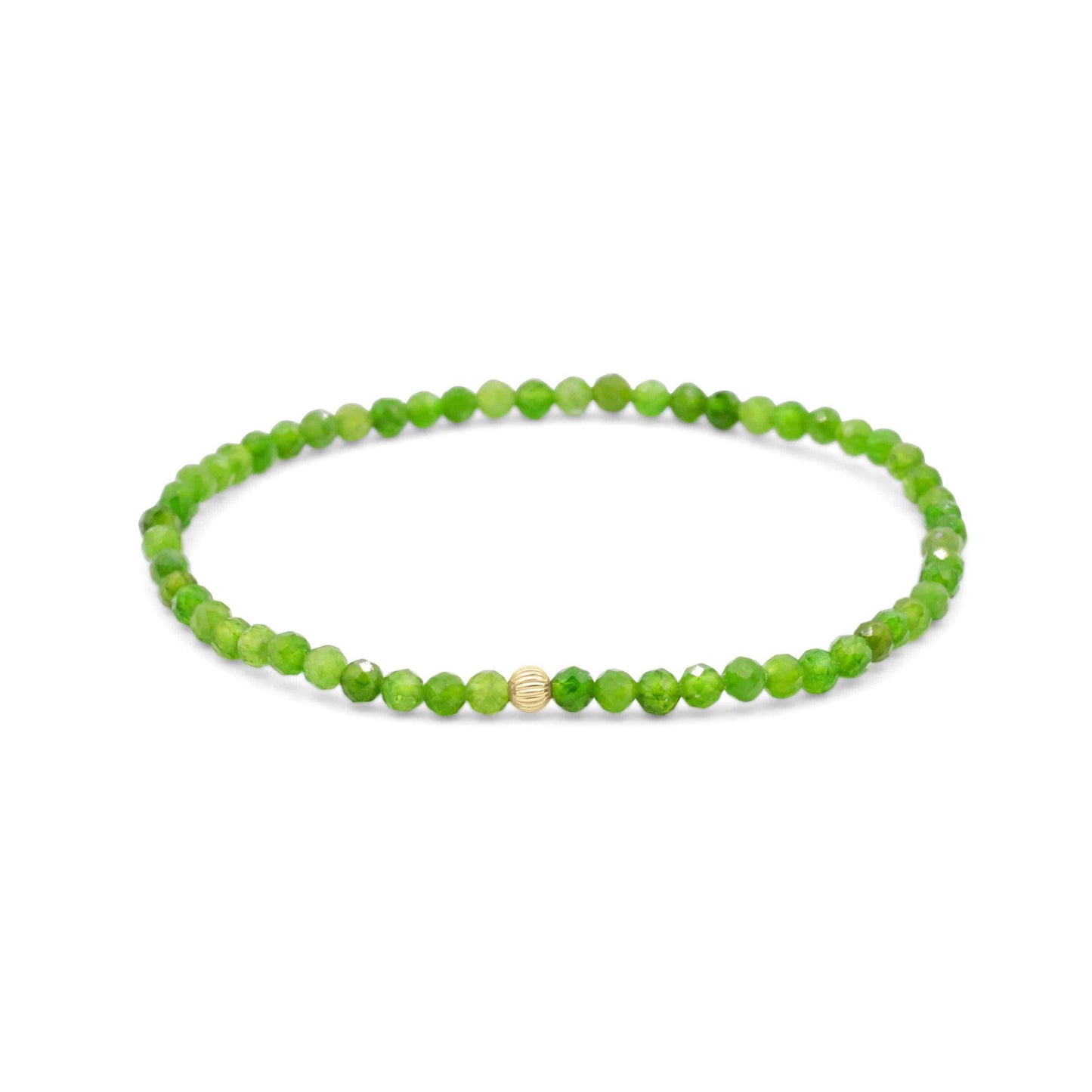 Shimmering chrome diopside gemstone set in 14K gold jewelry, showcasing vibrant green hues and polished finish.
