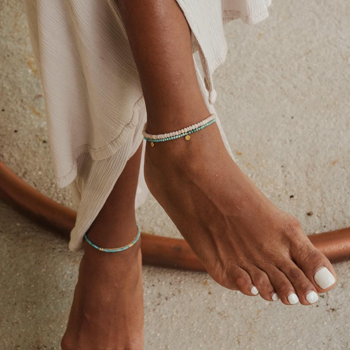 14K gold filled Sea Blush anklet from Earthly Abundance featuring delicate chain and shell charm on a white background.