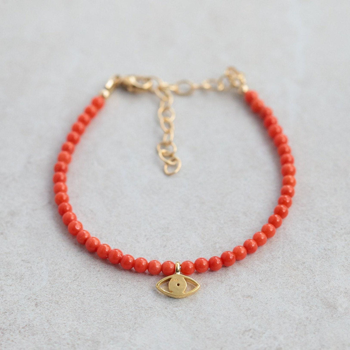 Italian Coral with Evil Eye pendant from Earthly Abundance, featuring vibrant coral and protective evil eye charm.