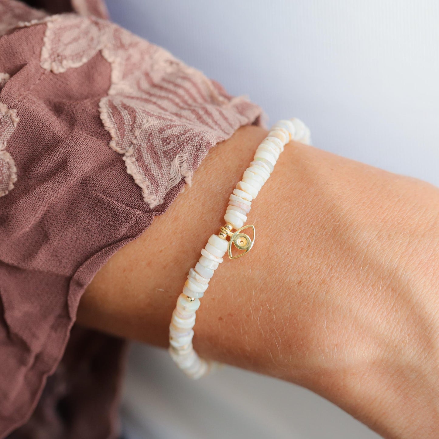 Australian Opal Evil Eye bracelet by Earthly Abundance featuring colorful opal beads and a protective evil eye charm.