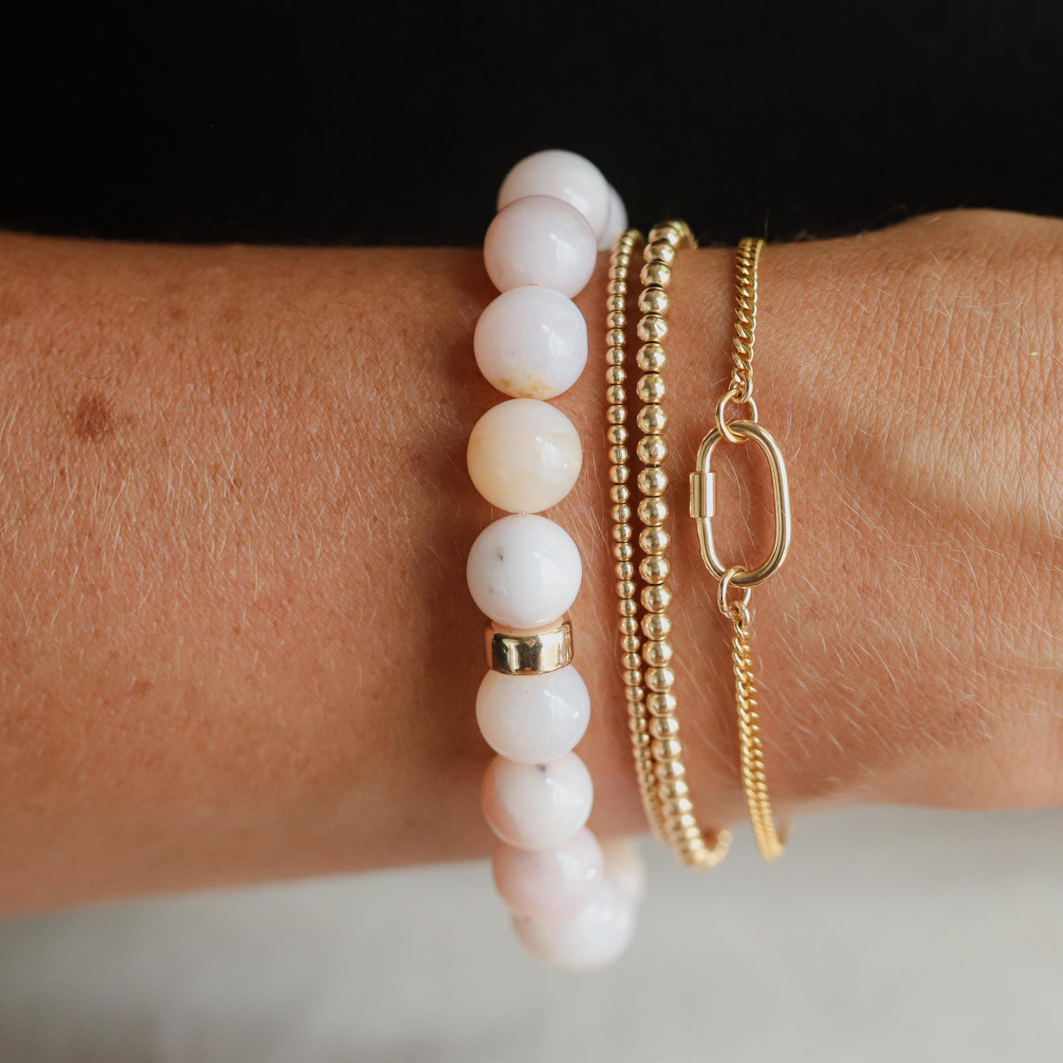 Pink opal bracelet with 14K gold accents from Earthly Abundance, featuring smooth polished pink opal stones.