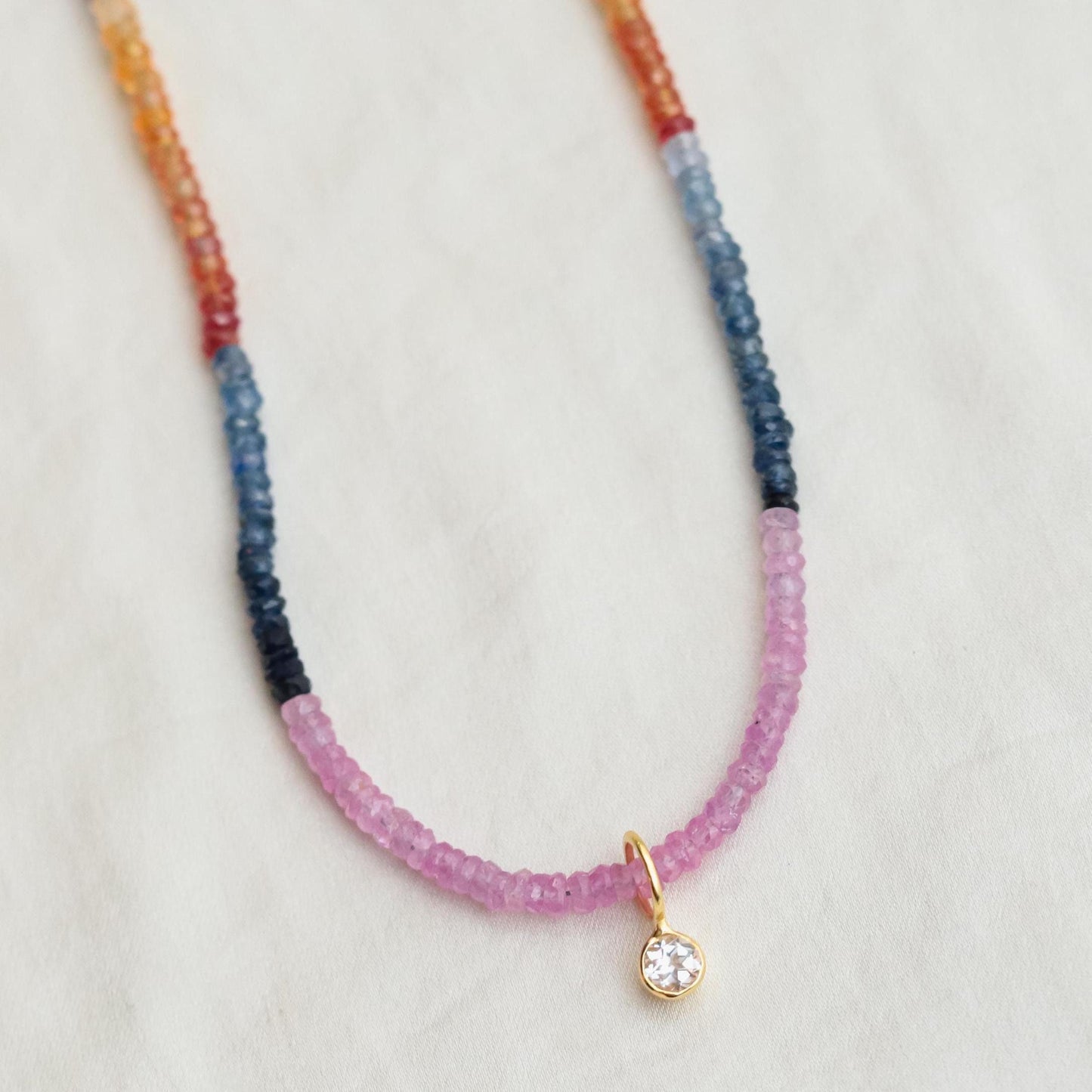 Multi sapphire necklace by Earthly Abundance featuring vibrant blue and pink sapphires on a delicate silver chain.