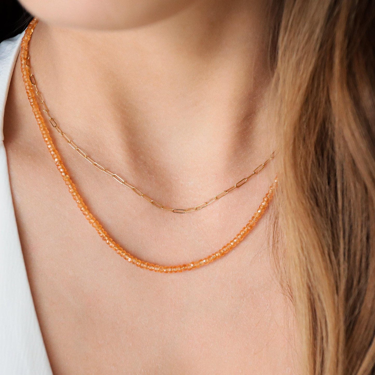 Orange sapphire necklace in 14K gold with a vibrant orange sapphire pendant, elegant jewelry piece by Earthly Abundance.