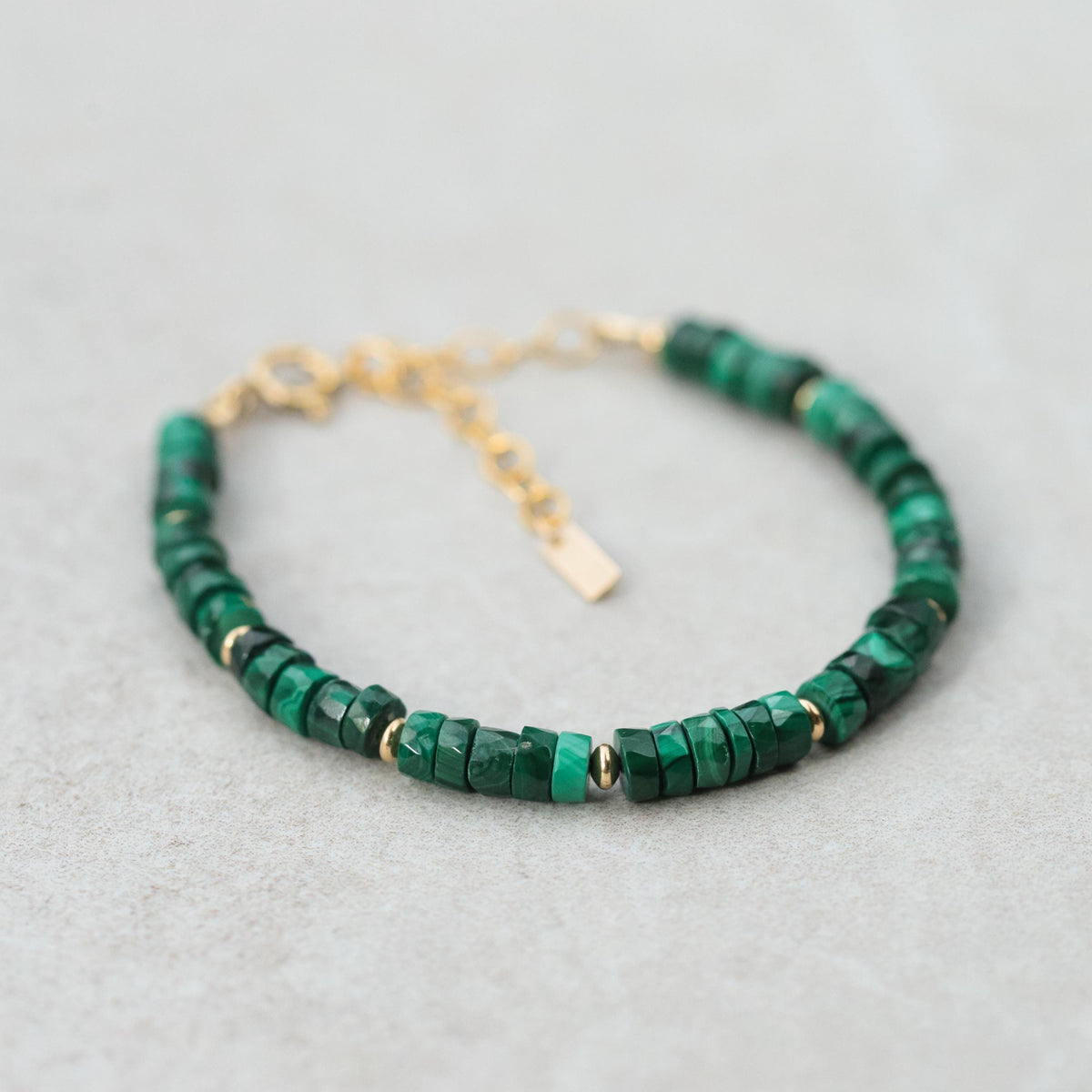 Malachite manifestation bracelet with 14K gold-filled beads, featuring polished green stone and elegant gold accents.