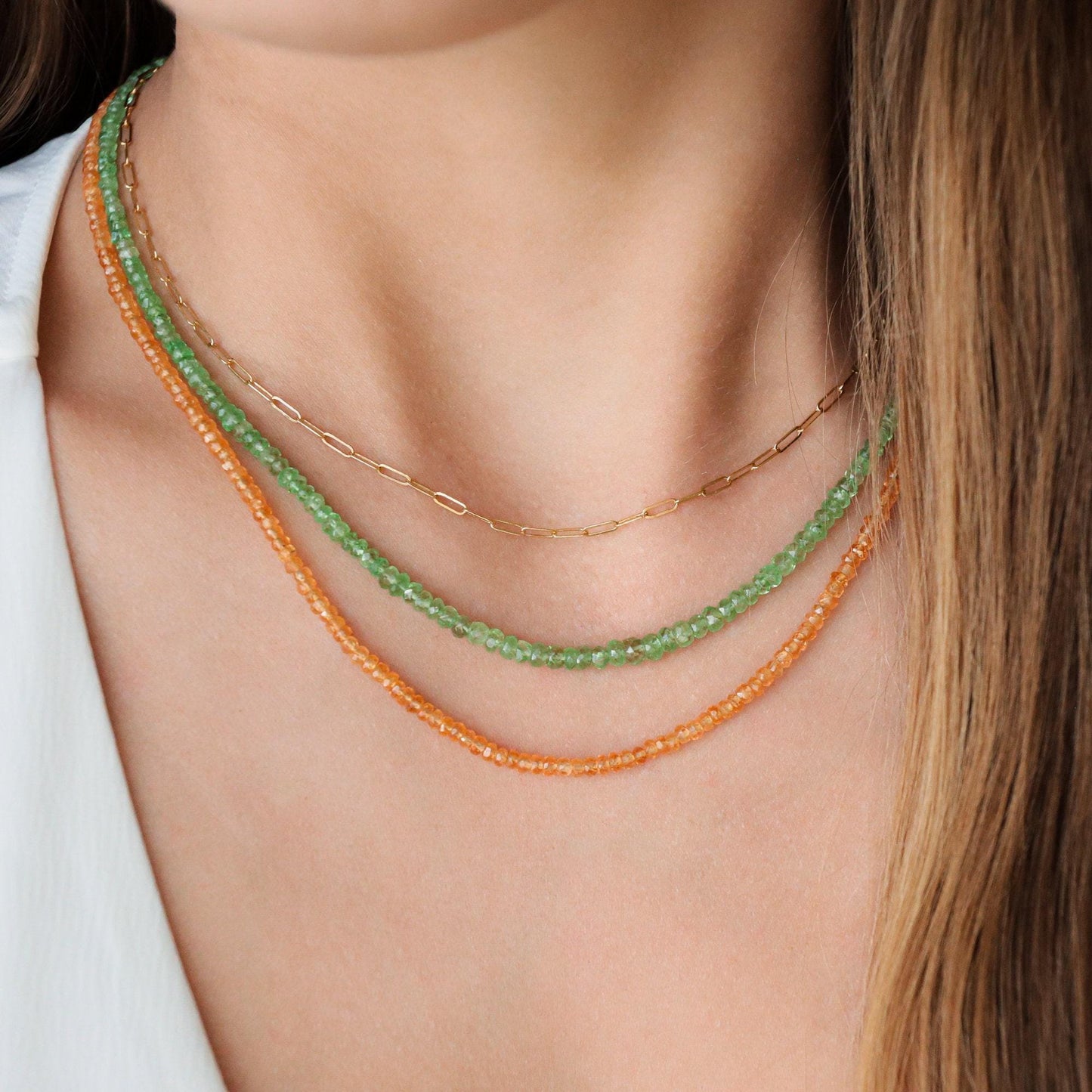 Orange sapphire necklace in 14K gold with a vibrant orange gemstone, featuring a delicate chain from Earthly Abundance.
