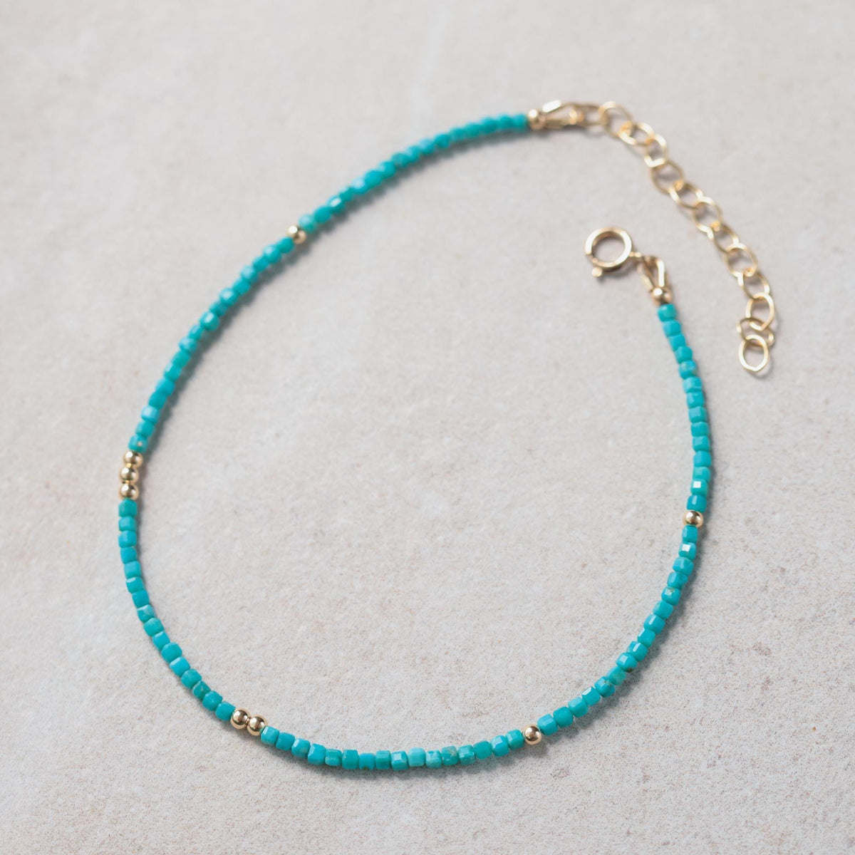Turquoise cube anklet from Earthly Abundance Jewelry featuring small turquoise beads on a delicate chain.