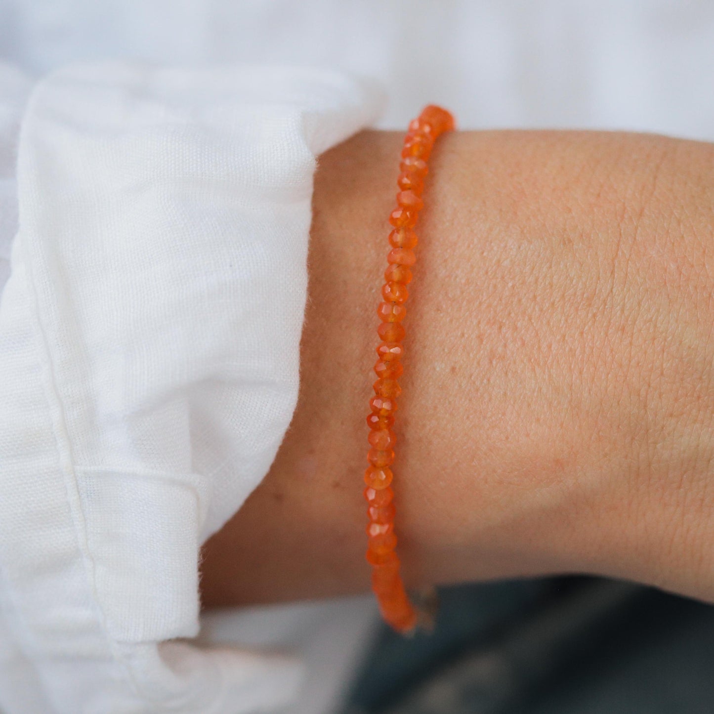 Carnelian bracelet with 14K gold accents from Earthly Abundance, featuring polished orange gemstones on a delicate chain.