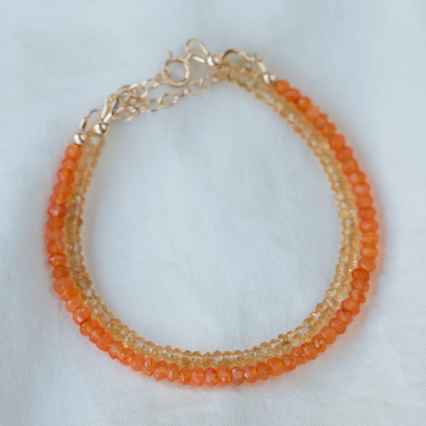Carnelian bracelet with 14K gold accents, featuring polished orange stones on a delicate gold chain, from Earthly Abundance.