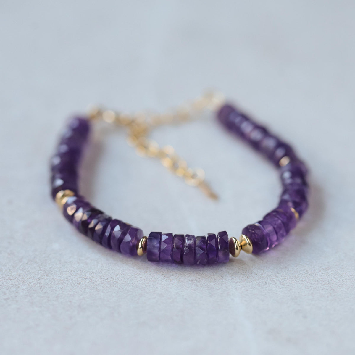 Earthly Abundance Amethyst Heishi Bracelet featuring small purple gemstone beads on a stretchy cord.