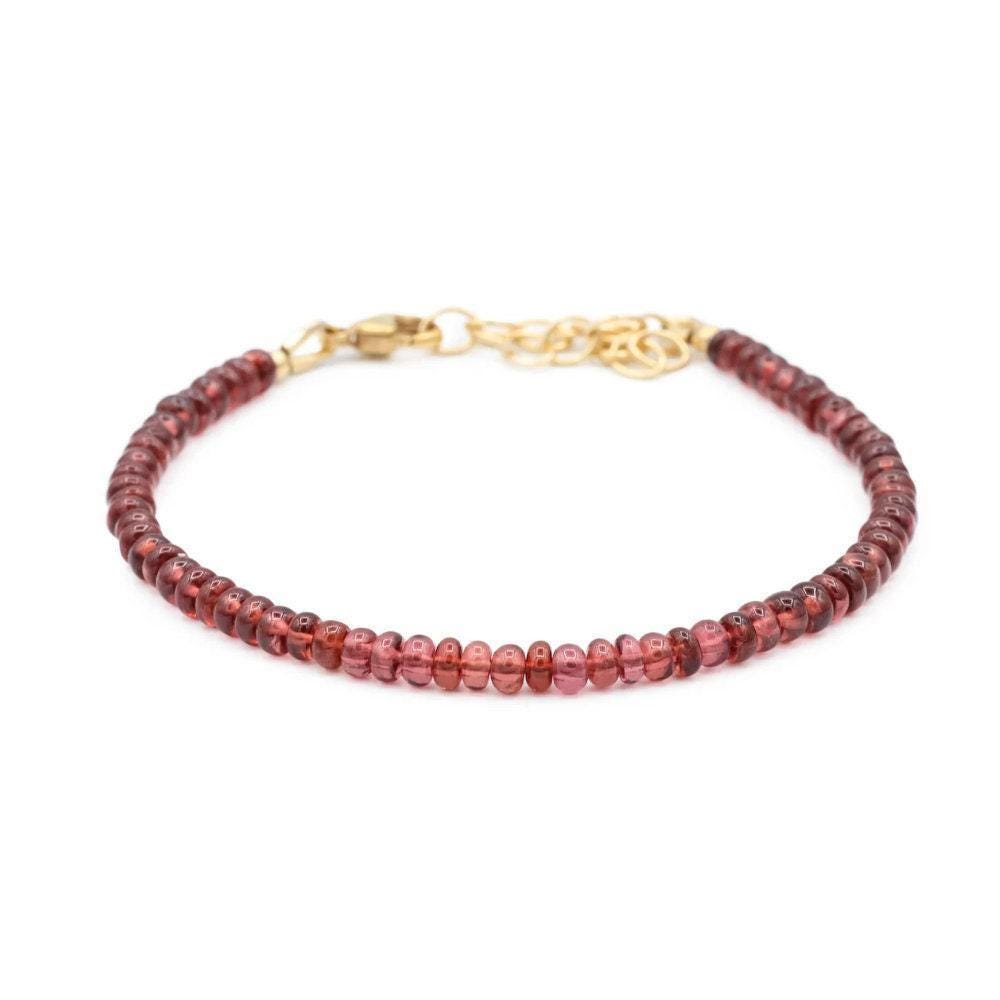 Smooth garnet rondel bracelet by Earthly Abundance featuring polished, deep red gemstone beads on a delicate string.