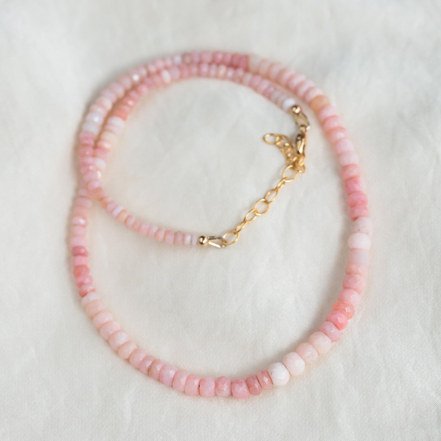Softly radiant pink opal necklace featuring a polished pink opal pendant on a delicate chain, by Earthly Abundance.