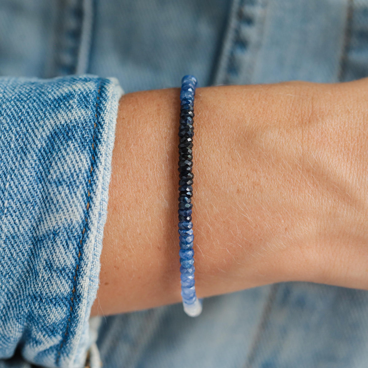 Blue sapphire ombre bracelet with 14K gold setting from Earthly Abundance, featuring a gradient of blue sapphires on a delicate gold chain.