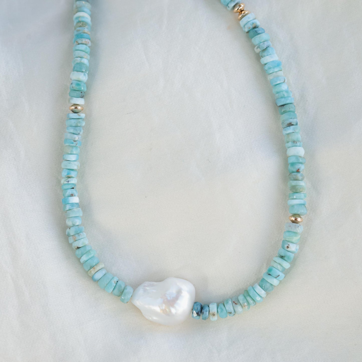 Larimar heishi and baroque pearl necklace by Earthly Abundance, featuring blue stones and irregular-shaped pearls on a delicate chain.