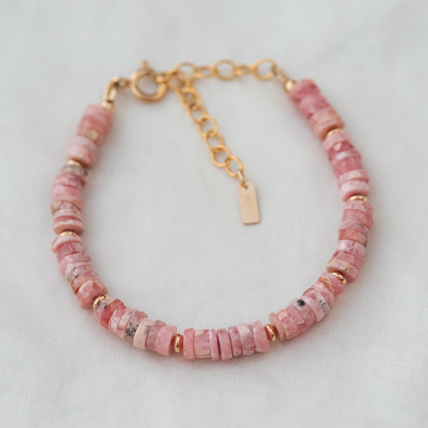 Renewal Rhodochrosite bracelet by Earthly Abundance featuring polished pink gemstone beads on a stretch cord.