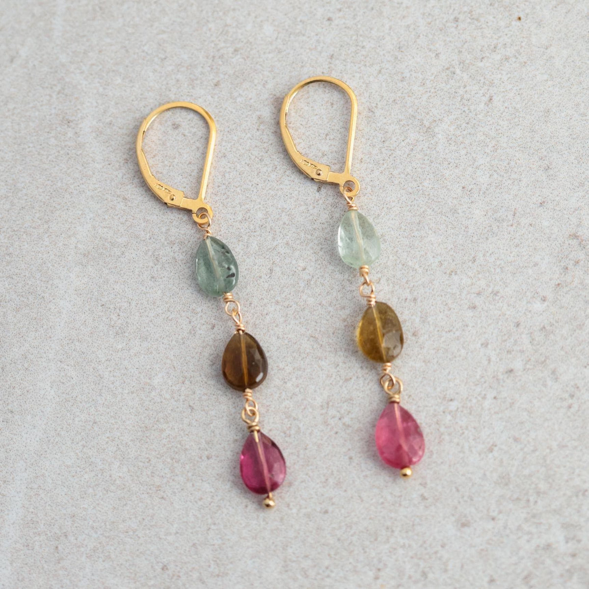 Delicate mixed tourmaline drop earrings by Earthly Abundance featuring colorful gemstone drops hanging from silver hooks.