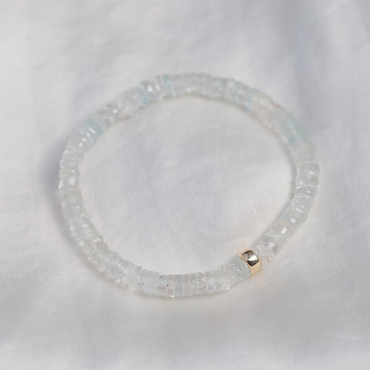 White Topaz Heishi bracelet by Earthly Abundance featuring smooth white gemstone beads on an elastic band.