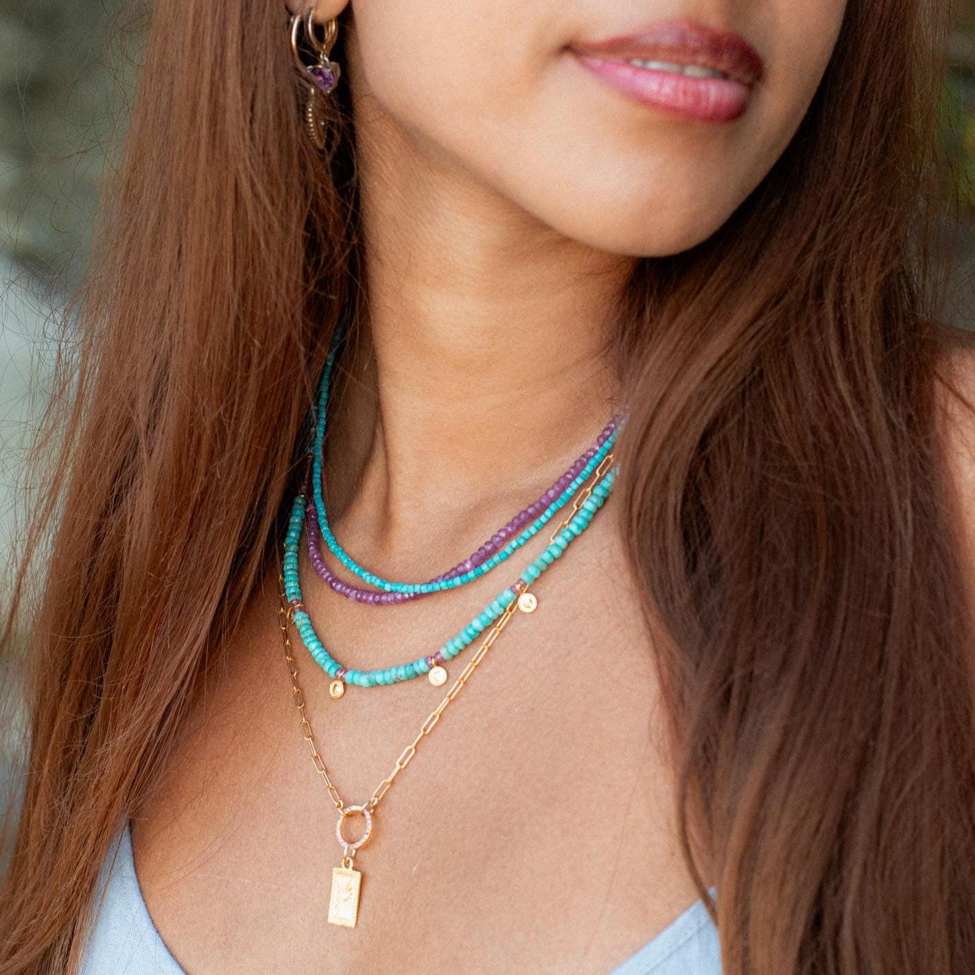 Turquoise cube necklace from Earthly Abundance featuring a vibrant blue gemstone pendant on a silver chain.