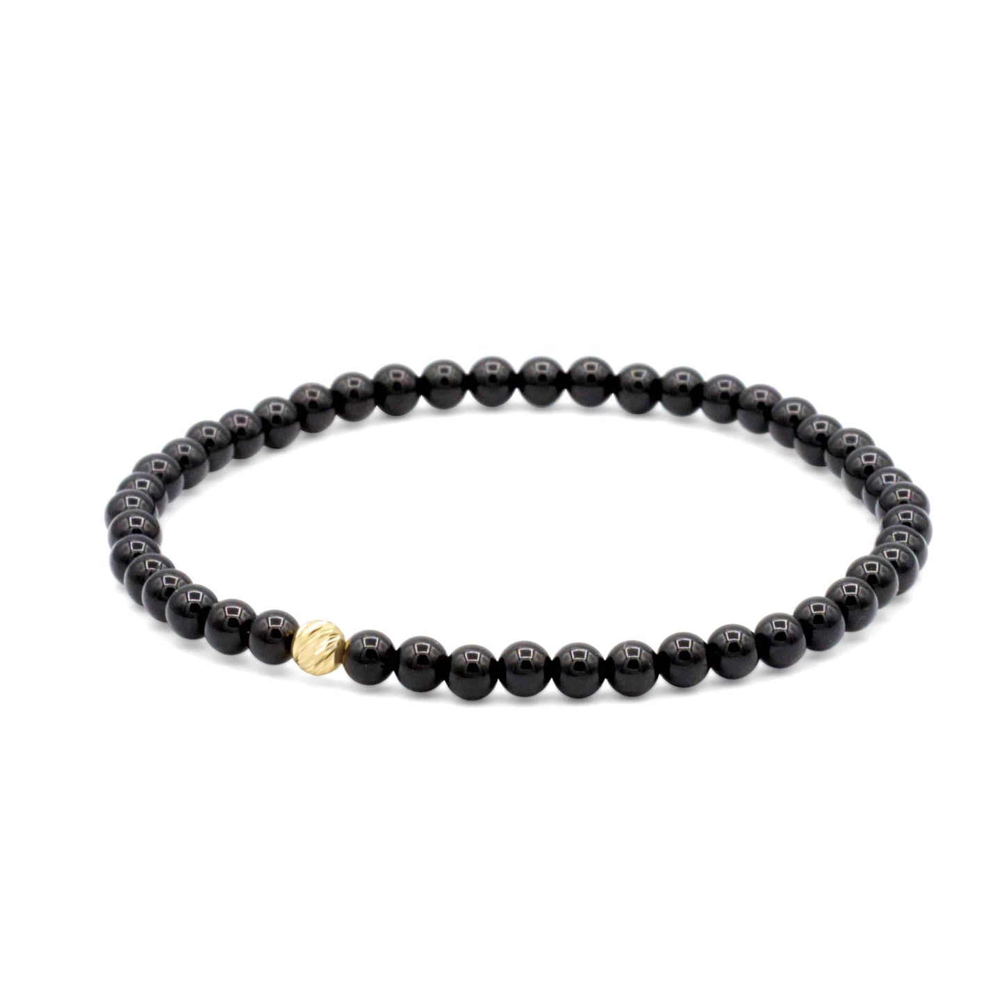 Black Tourmaline bracelet with 4mm beads and 14K gold accents from Earthly Abundance Jewelry, displayed on a neutral background.