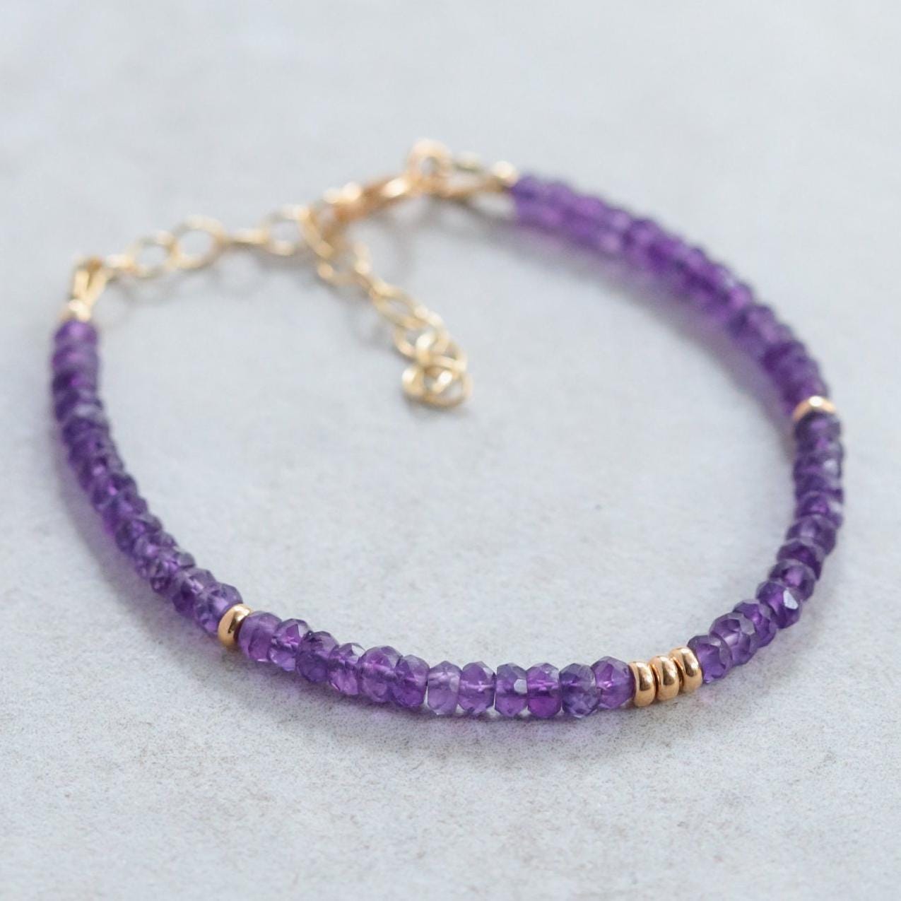 African Amethyst bracelet featuring polished purple beads on a stretchy cord, designed by Earthly Abundance Jewelry.