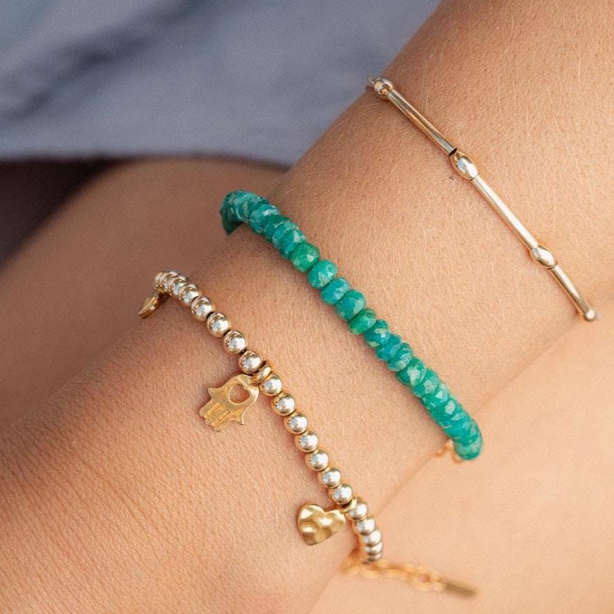 Heart-centered Amazonite bracelet featuring smooth, blue-green beads with a silver heart charm, crafted by Earthly Abundance.