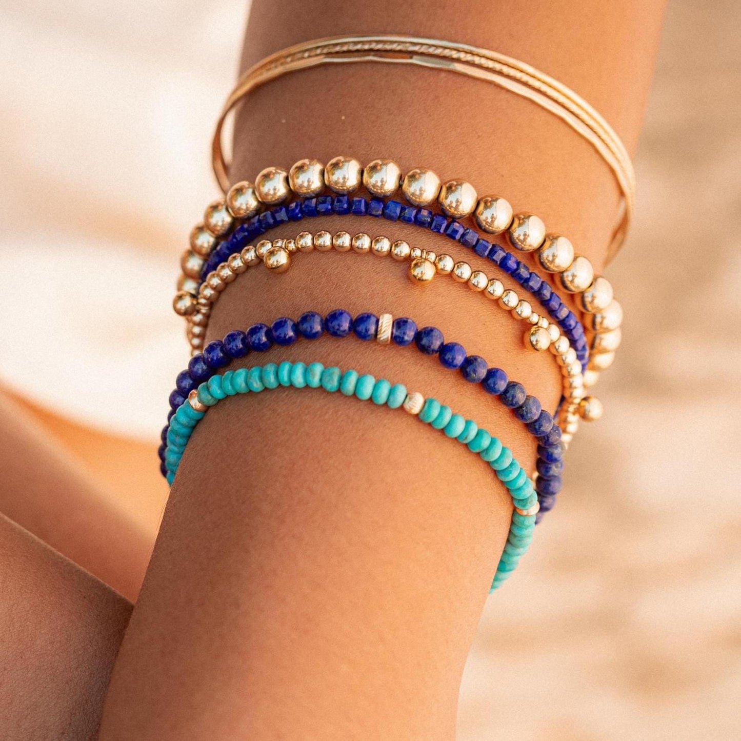 Lapis Lazuli cube bracelet with 14K gold accents, handcrafted by Earthly Abundance, featuring deep blue stones and gold clasp.